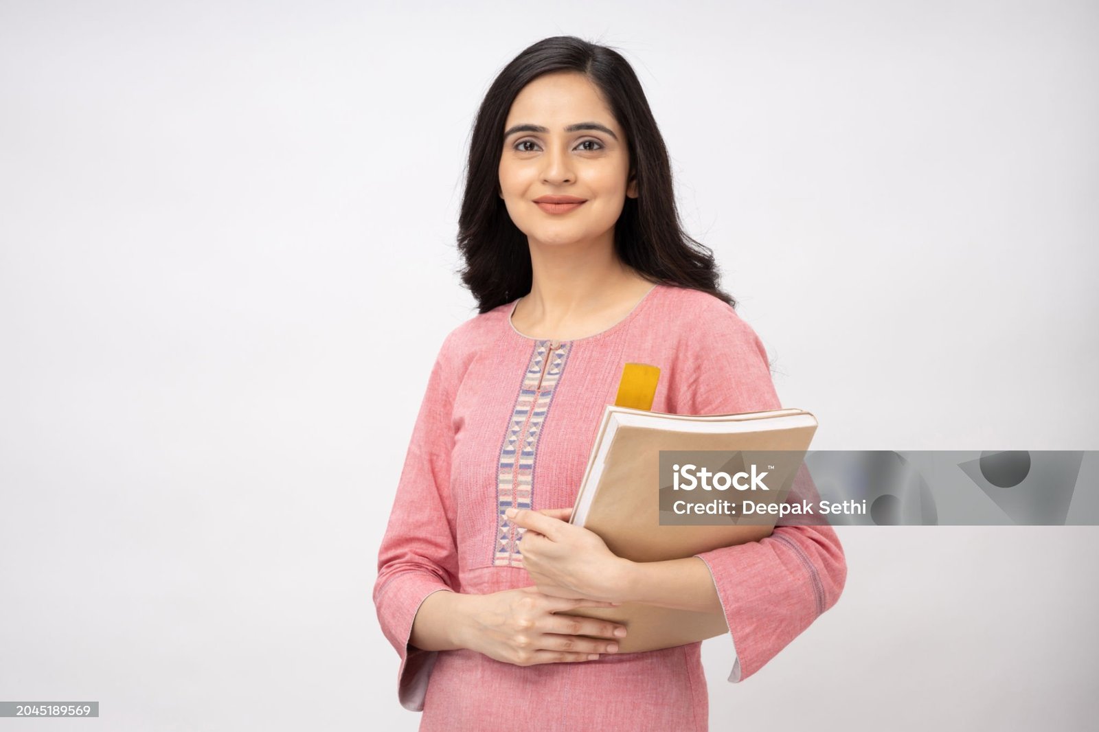 Portrait of Indian young woman wearing casual kurta on white background